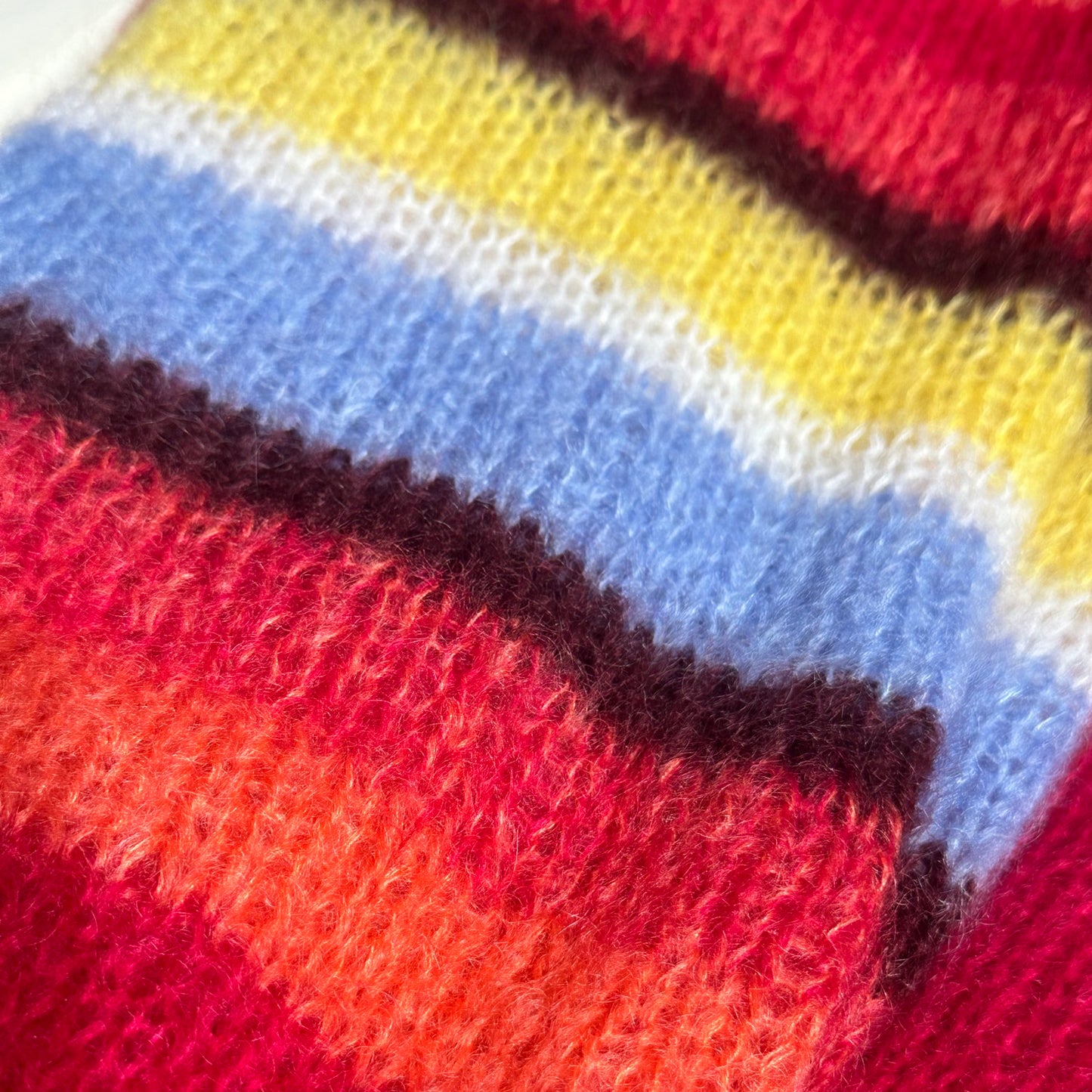 Striped sleeve detail on a hand-knitted jacket
