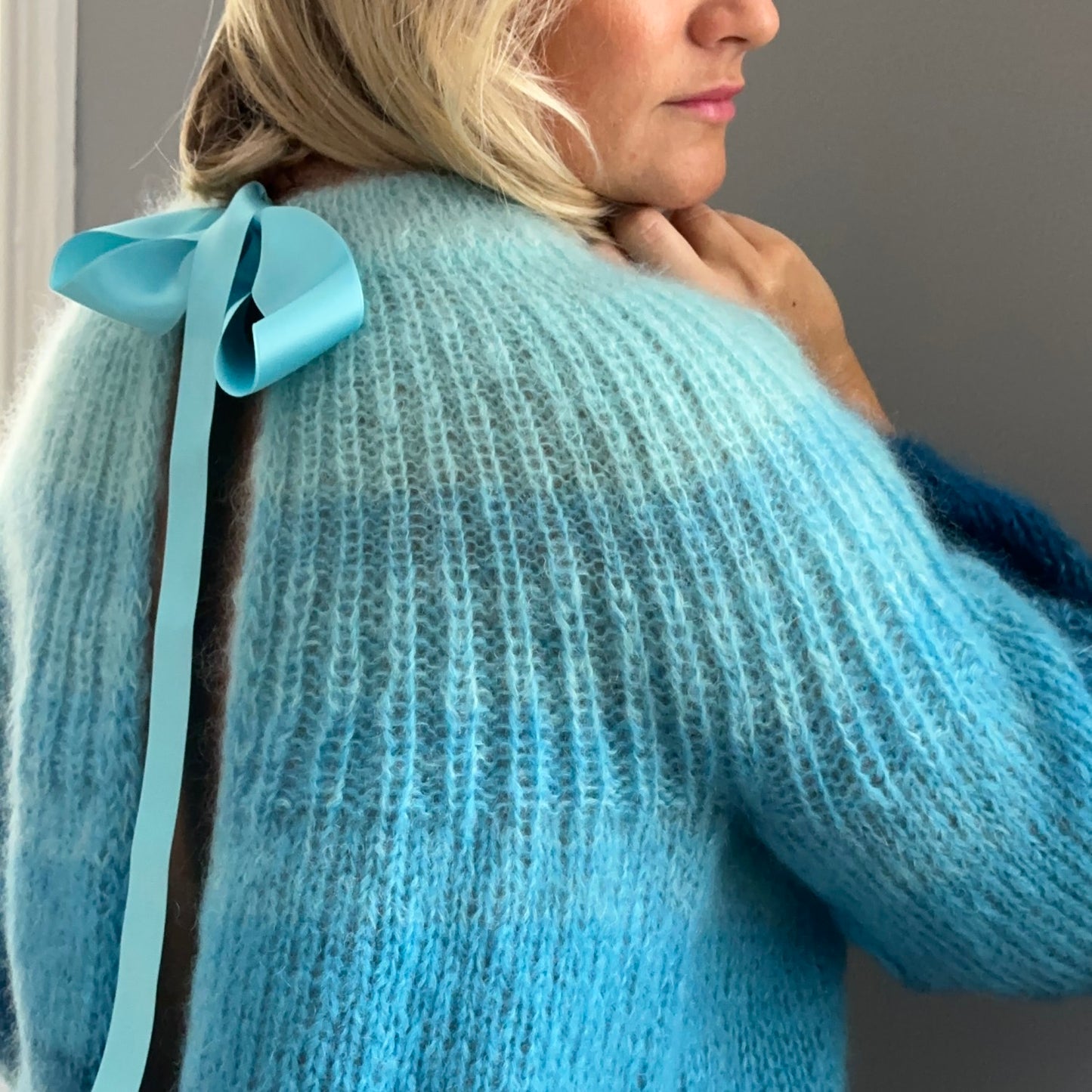 Unique open-back cardigan in soothing aqua shades